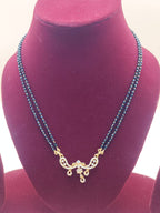 Double-line black beads mangalsutra chain with crystal-studded pendant with drop design.