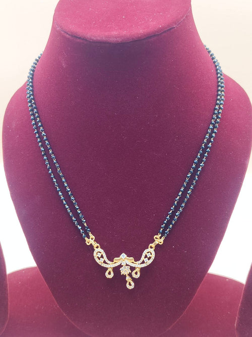 Double-line black beads mangalsutra chain with crystal-studded pendant with drop design.
